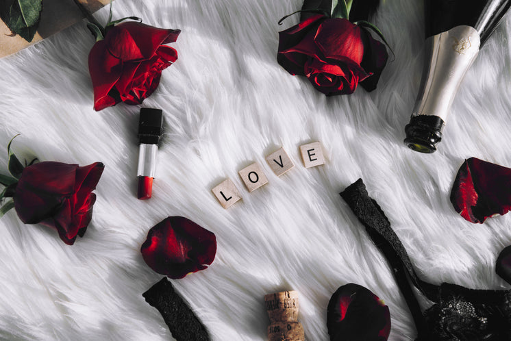 Valentine's Day themed background with LOVE letters, champagne, and red roses