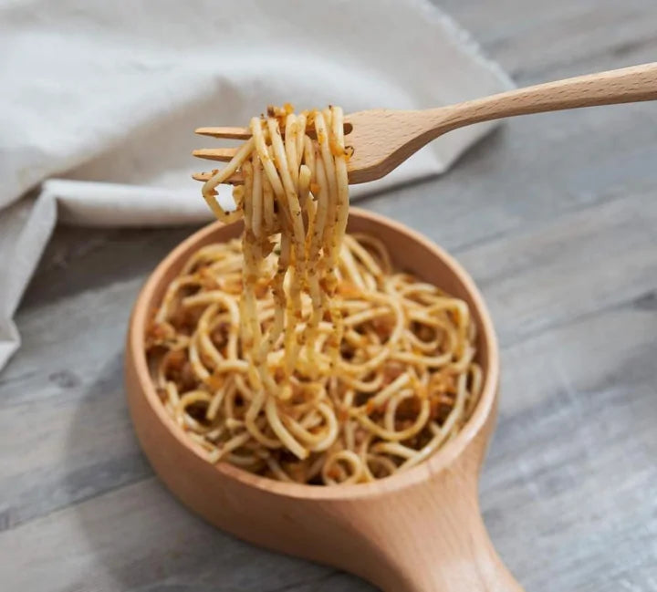 a person using a fork from the Reusable Bamboo Cutlery Set