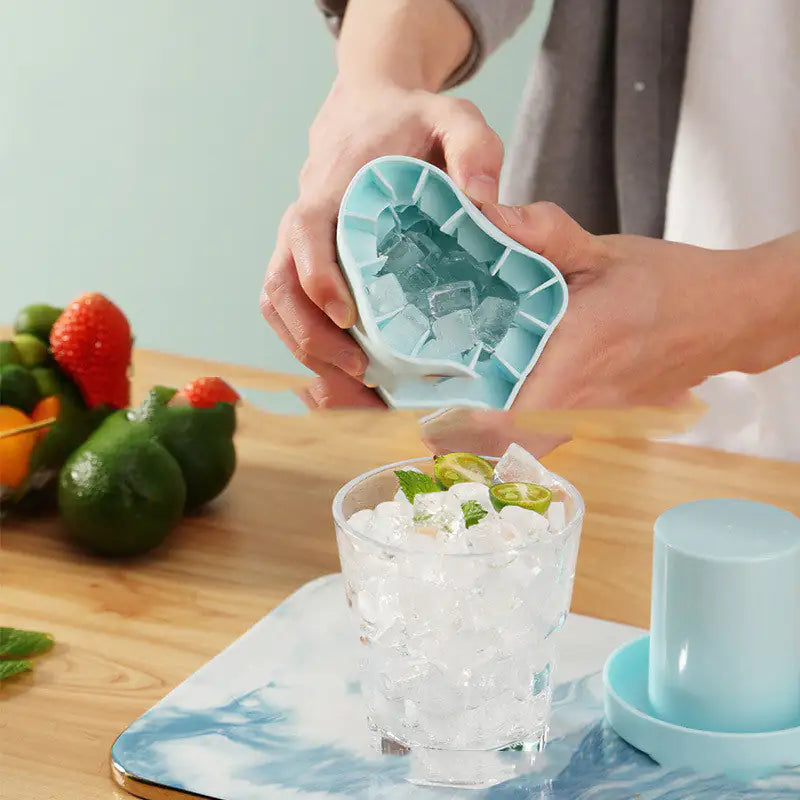 man crushing Cylinder Ice Cube Mold to pour ice into a glass