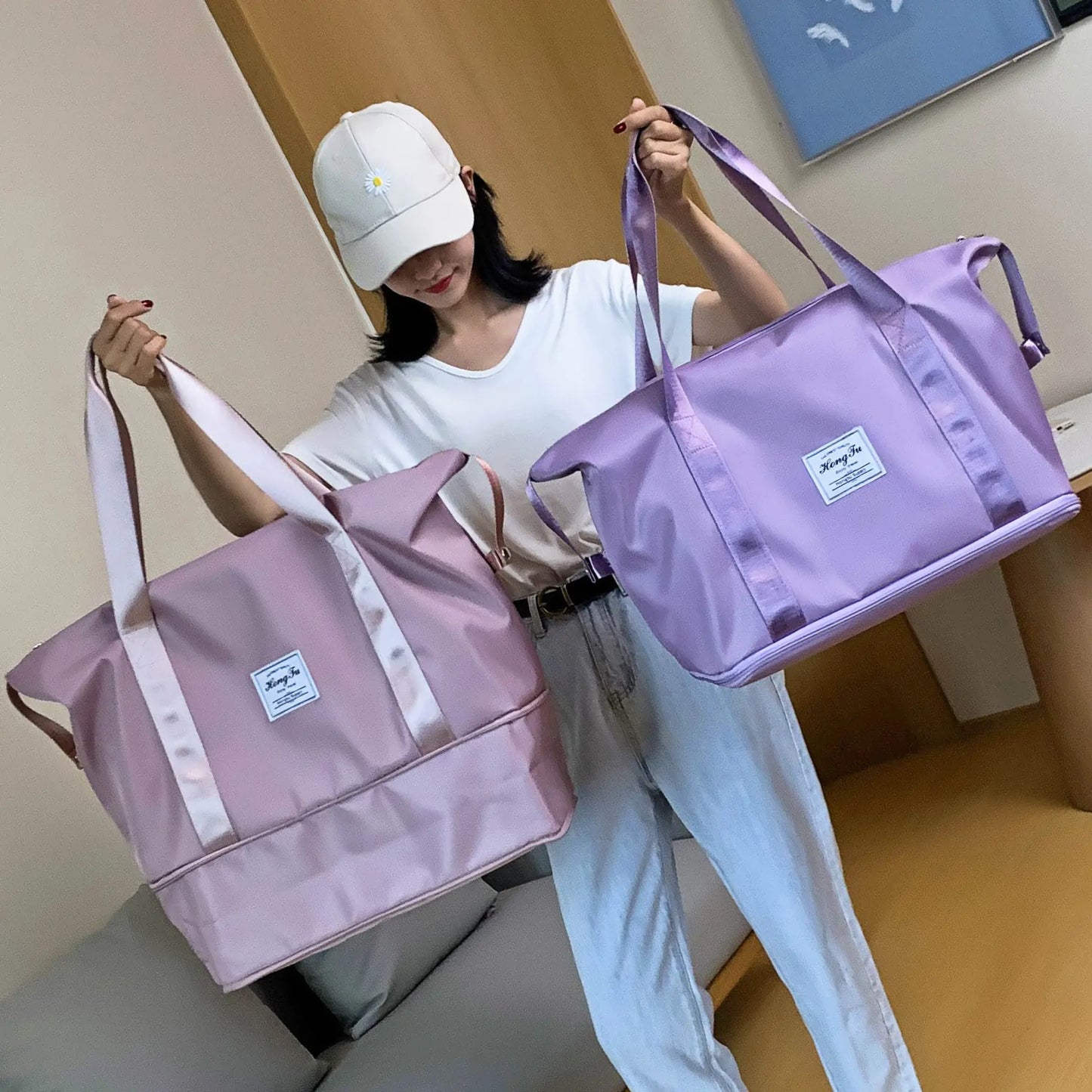 woman holding 2 Foldable Waterproof Travel Bags