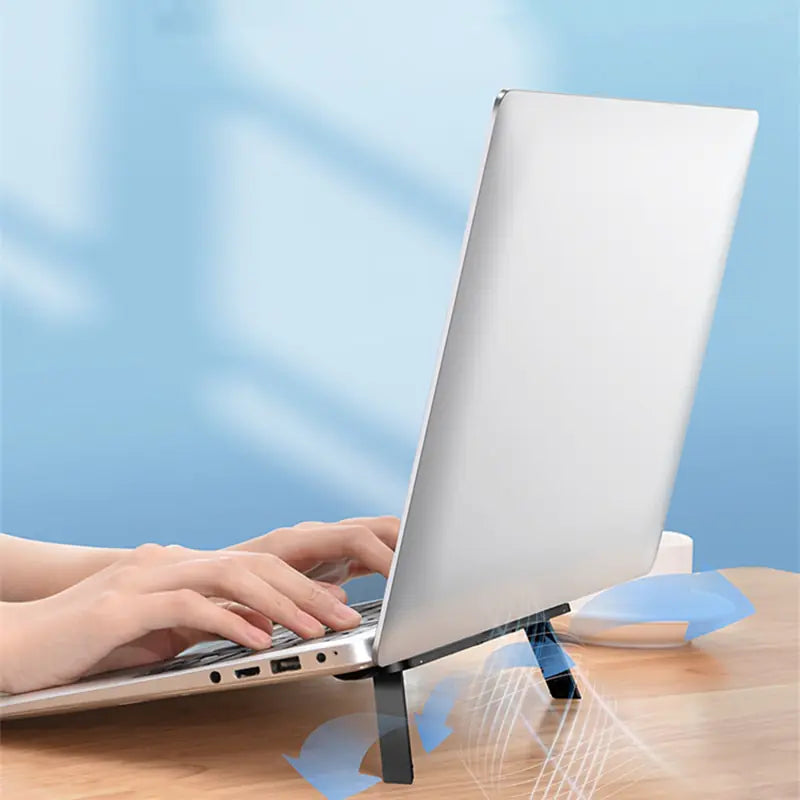 person typing on a laptop using the Ergonomic Laptop Stand