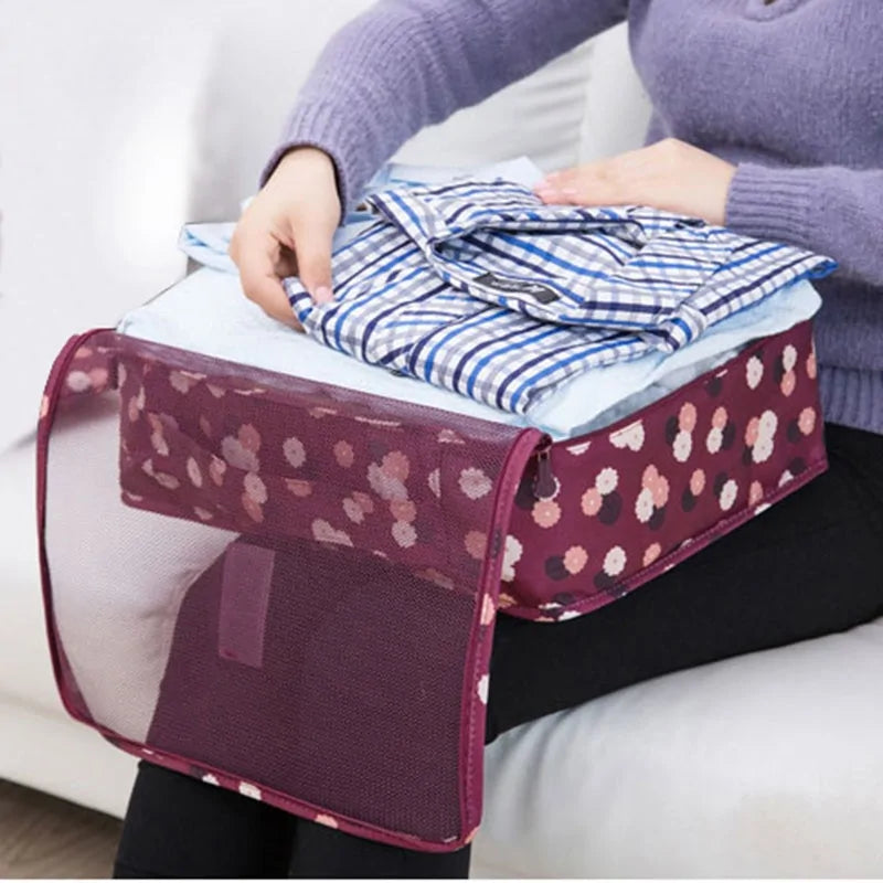 person placing shirts into a Travel Packing Cube