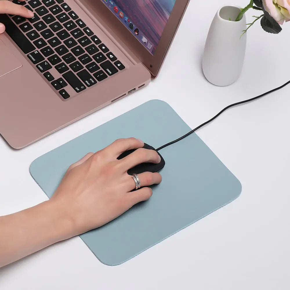 person moving a mouse on a Waterproof Desk Mousepad