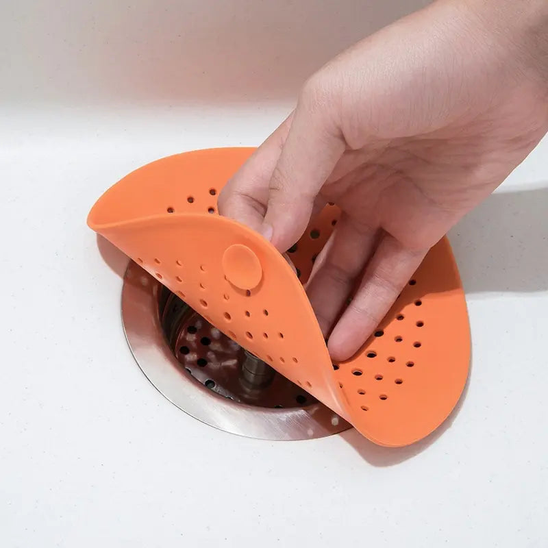 Universal Sink Strainer being placed over a sink drain