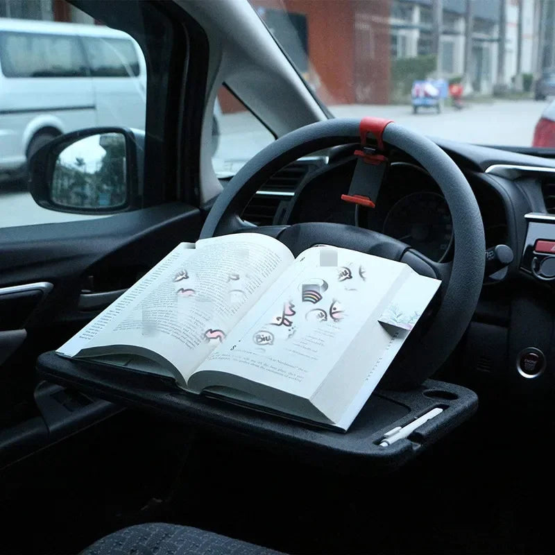 an open book resting on the Car Steering Wheel Tray