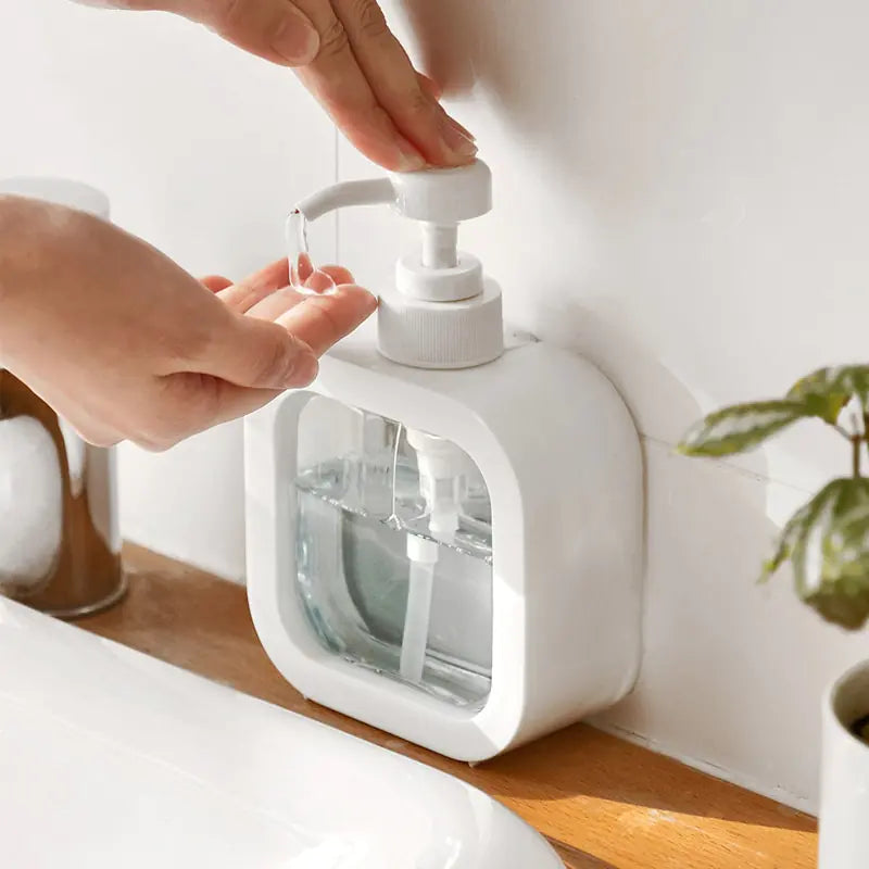 person pumping soap into their hands using Refillable Soap Dispenser Bottle