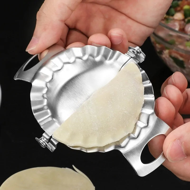 person holding a Stainless Steel Dumpling Mold with a folded dumpling
