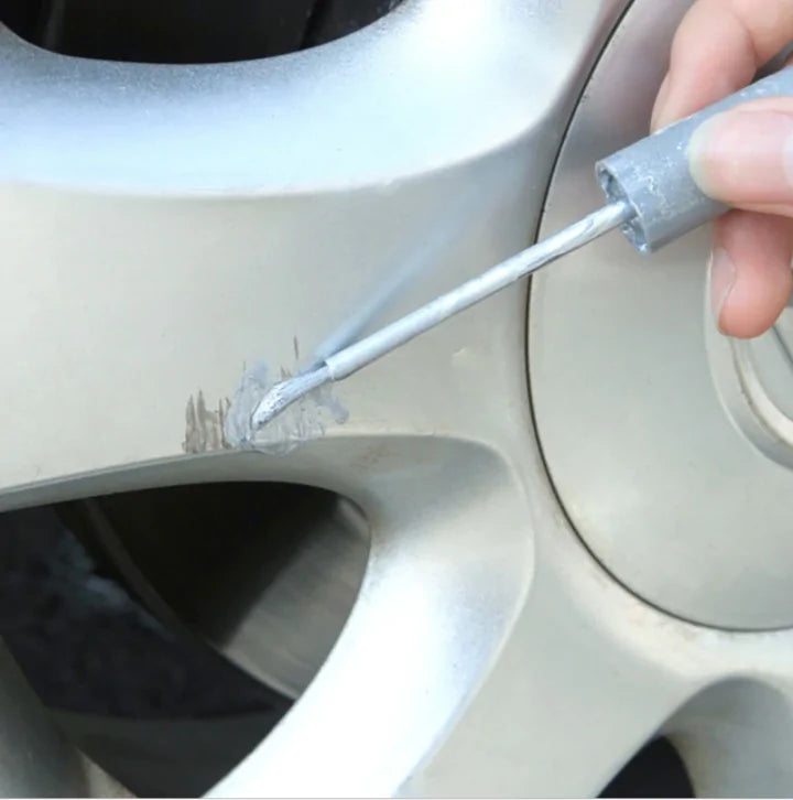 applying Wheel Rim Scratch Repair paint to a scratch on a tire rim
