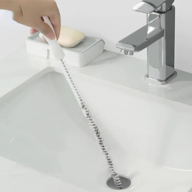 Flexible Drain Cleaning Brush being plunged into a sink drain