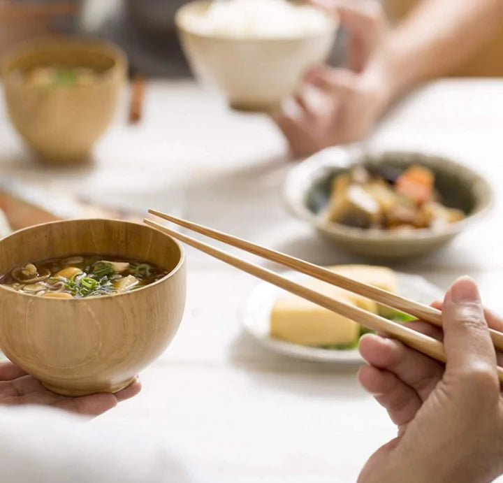 a person using chopsticks from the Reusable Bamboo Cutlery Set