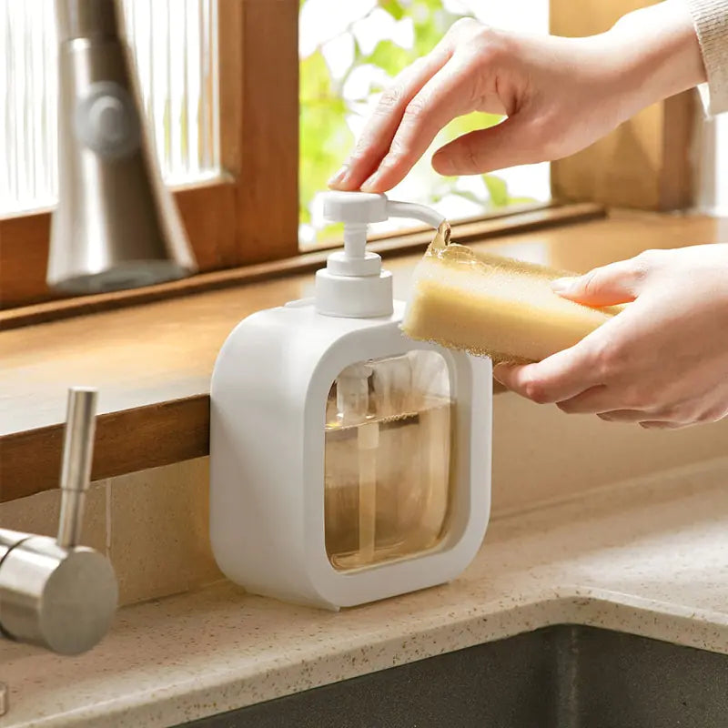 person pumping soap onto a sponge using Refillable Soap Dispenser Bottle