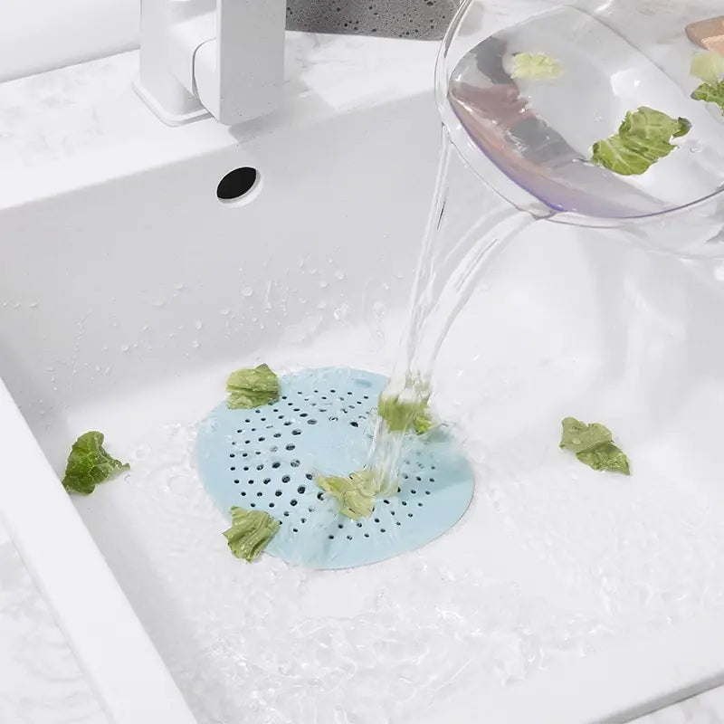 water being poured over the Universal Sink Strainer covering a drain